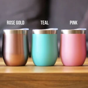 Three metallic tumblers in rose gold, teal, and pink colors.
